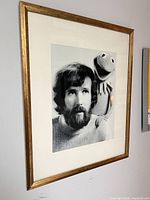 Gold frame on wall displaying size, color and mat