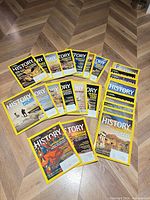 All 27 magazines spread out on floor showing covers