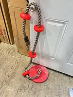 Full view of rope swing showing seat, step discs, and carabiner