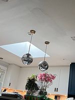 Both pendant lights hanging over kitchen island
