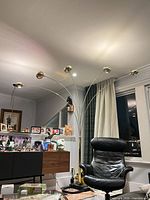 Full view showing six arched arms and brass dome heads