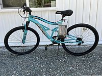 Right side view of entire Swift teal/turquoise 26" full suspension mountain bike showing frame, wheels, drivetrain and kickstand
