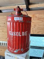 Front view showing GASOLINE stencil, ribbed body, cap and handle