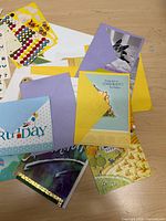 Group of greeting cards with envelopes displayed on tabletop