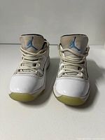 Front view showing both shoes, laces, patent leather, Jumpman logo