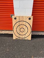 Front view of pine target board with printed rings and branding