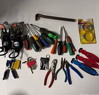 All items laid out including rod holders, screwdrivers, pliers, wrenches, pry bar, clamp, hex keys, hose clamps, pouch