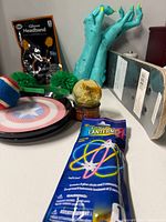 Assorted toys including skateboard, monster hands, glow items, flying disc, ball, capsule