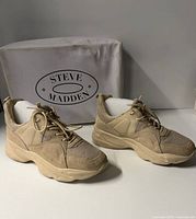 Full view of both sneakers with box