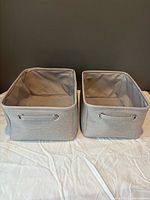 Two grey fabric storage baskets front view showing grommet handles