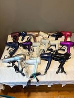 All 16 hair dryers grouped on table