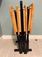 All four folded TV trays stored in stand