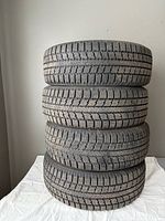 Stack of four Toyo winter tires showing tread depth and overall condition