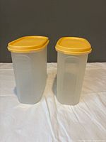 Two oval Tupperware containers front view