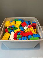 top view of multicolor building blocks inside beige plastic bin