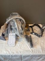 Steamer base unit, hose, nozzle, accessories and manual still in plastic