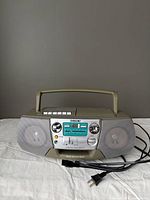 Front view showing speakers, CD and cassette controls, branding, power cord