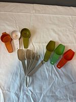 Group shot of all 11 Tupperware measuring spoons laid out to show variety