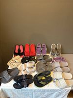 Overview of all slide sandal pairs on table