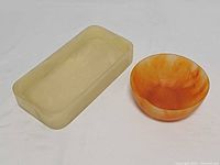 Top view of cream resin tray and orange resin bowl