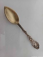 Full view of Gorham Versailles sterling spoon showing gilt bowl and ornate handle