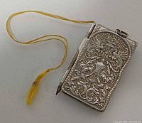 Closed notepad with pencil in slot and yellow cord