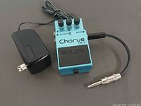 Top view of pedal with power adapter and patch cable