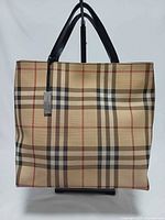 Front view of Burberry Nova Check tote showing plaid pattern and black handles