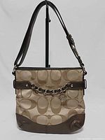 Front view of Coach optic Signature bag showing fabric pattern, chain accent and strap