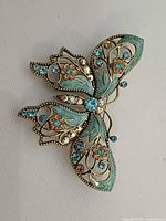Front view of enamel butterfly brooch