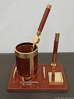Full view of pen cup with letter opener, pen on base