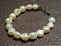 Full view of bracelet showing pearls and clasp