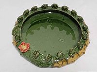 Top view showing full planter, frogs, red flower accent, interior basin