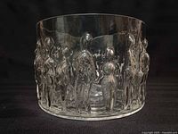 Front view of clear art glass bowl showing raised human figure motif