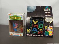 Front view of both boxed items showing graphics and size comparison