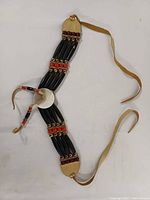 Full view of choker laid flat showing beads, shell concho and leather ties