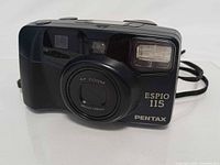 Front view showing lens retracted, model labeling and flash