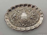 Full view of ornate sterling silver pin tray front
