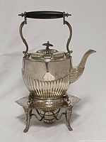 Front view of silver-plated spirit kettle on stand