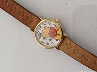 Front view showing dial, case, crown and part of strap