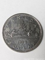 Reverse showing CANADA 1986 DOLLAR with Voyageur design
