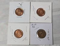 All four Canadian 1¢ coins in flips front view