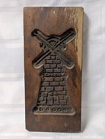 Full view of carved wooden mold front showing windmill design