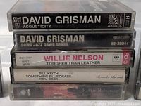 Stack of five cassette cases showing album titles