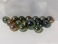 Group of reflective glass marbles showing quantity and finish
