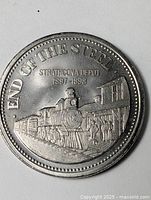 Obverse showing END OF THE STEEL locomotive scene