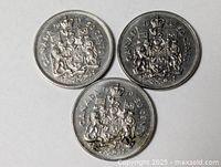 Front view of three Canadian 50 cent coins