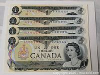 Front view of all four consecutive $1 bills