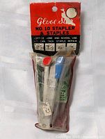 Front view of sealed stapler set showing stapler and staple tubes in package