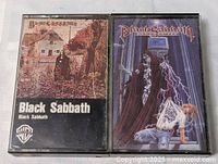 Front view of both cassette cases showing album art